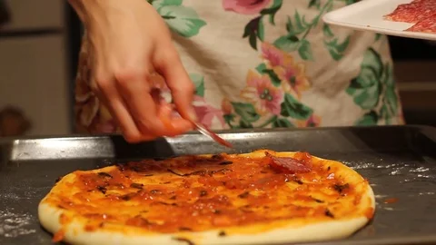 Female hands complete pizza ingredients on dough. Stock Footage 81037982