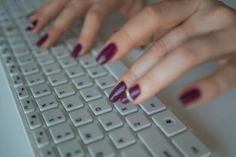 Female hands on a computer keyboard close-up. Woman working on computer Stock Photos