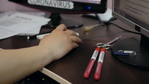 Female hands on a computer keyboard. Hands and test tubes Covid-19 Stock Footage 127503450