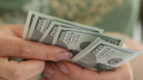 Female hands count dollars. front view. dollar bills close-up. money in hand. Stock Footage 244471820