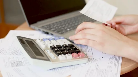 Female hands count received utility bills on a calculator Video stock 278347309