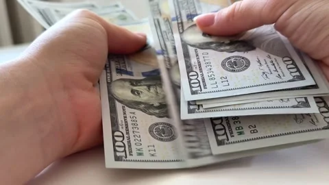 Female hands counting and spreading one hundred dollar bills on white Stock Footage 345172965