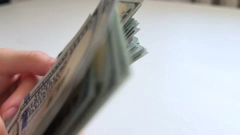 Female hands counting and spreading one hundred dollar bills on white Stock Footage 345174012