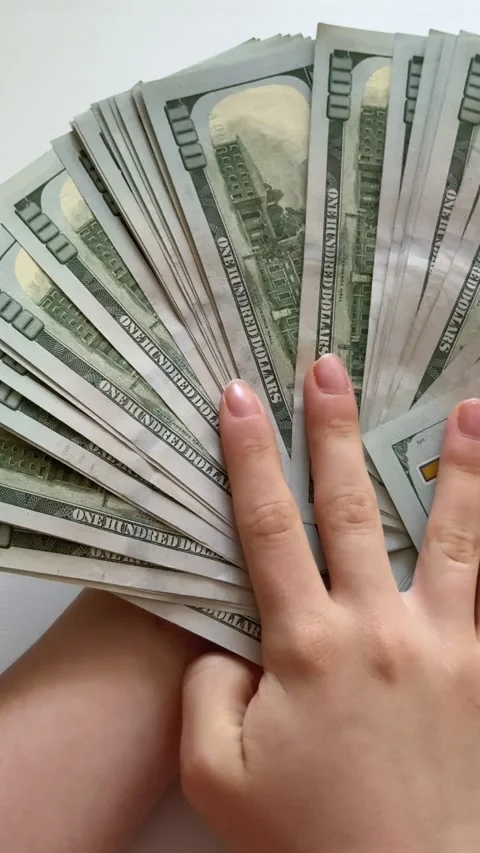 Female hands counting and spreading one hundred dollar bills on white Stock Footage 345179618