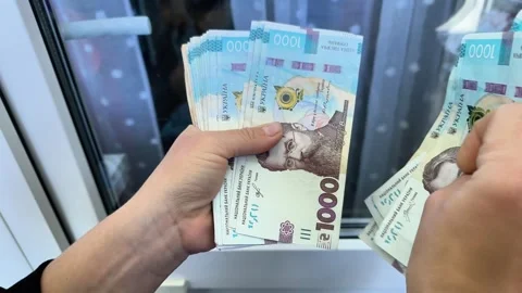 Female hands counting large stack of Ukrainian hryvnia banknotes close up. Stock Footage 339423366