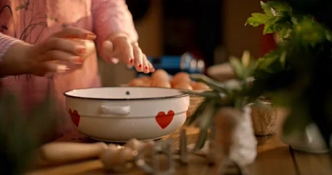 Female hands cracking eggs into a bowl, preparing breakfast in the kitchen. Stock Footage 149502235