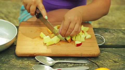 Female hands cut an apple for fruit salad into pieces. Stock Footage 94152978