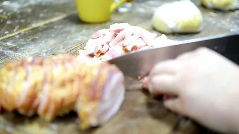 Female hands cut bacon with a large iron knife Stock Footage 87091947