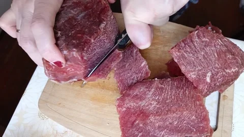 Female hands cut beef meat with a knife on a wooden board Stock Footage 319980671