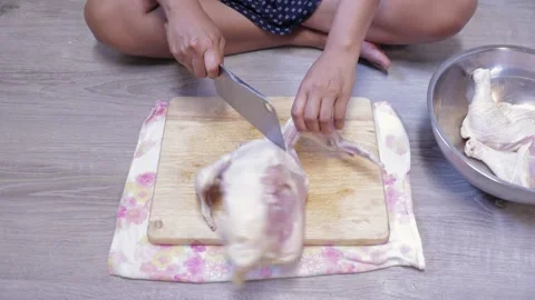 Female hands cut chop raw whole chicken on wood cutting board with knife cleaver Stock-Footage 155308284