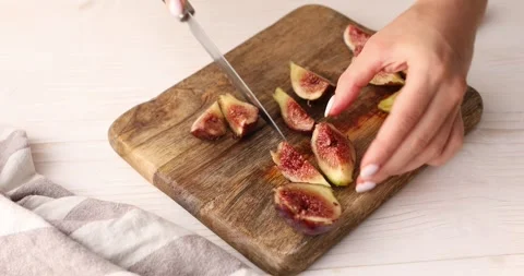 Female hands cut figs into slices Stock Footage 249286444