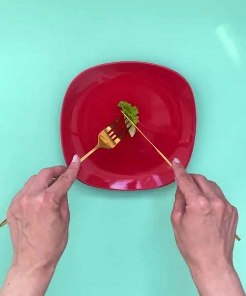 Female hands cut a leaf of greens with cutlery, the concept of weight loss,.. Stock Footage 277936284