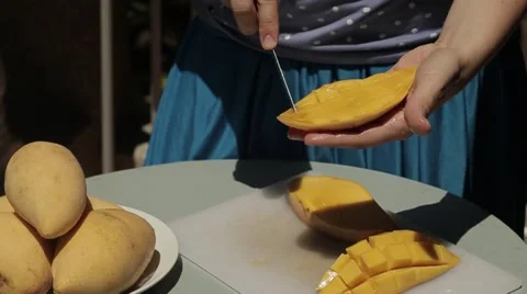 Female hands cut mango Stock Footage 52588420