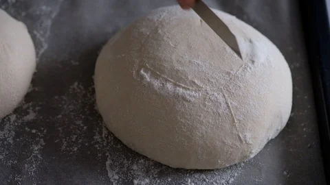 Female hands cut raw bread dough. Bread. 4K. Stock Footage 128255927