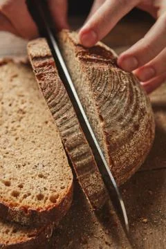 Female hands cutting bread Stock-Fotos