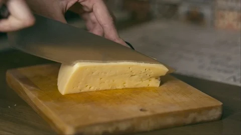 Female hands cutting cheese on kitchen. Video stock 86133954