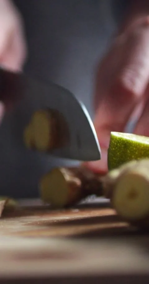 Female Hands Cutting Ginger Root with a Knife on a Board for Making... Stock Footage 344454639