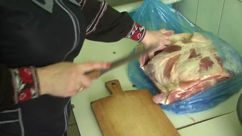 Female hands cutting meat on the table in the dining room. Video stock 308825809