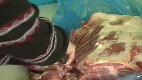 Female hands cutting meat on the table in the dining room. Video stock 308826060