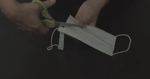 Female Hands Cutting Open A Face Mask With Scissors Stock Footage 152783805