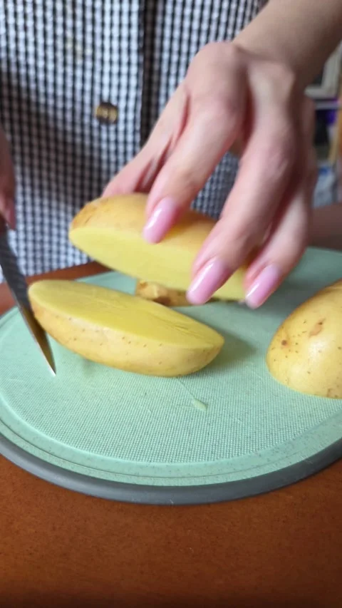 Female Hands Cutting Potatoes on Kitchen Board, Close Shot Stock Footage 338188766