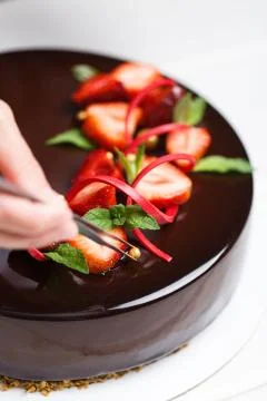Female hands decorating cake Stock Photos