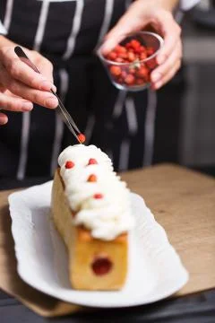 Female hands decorating cake Stock Photos