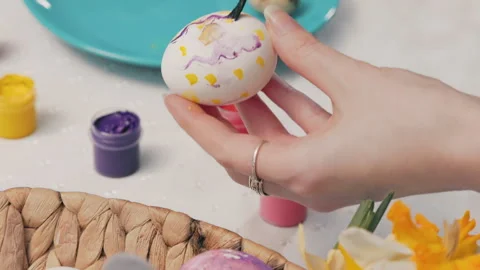 Female hands decorating eggs for Easter. Close up. Top view Stock Footage 219787349