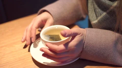 Female hands dip a tea bag in a white mug Stock Footage 101339819