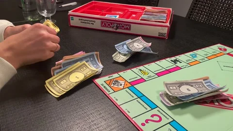 Female Hands Distributing Paper Money In A Monopoly Game. close up shot Vídeo Stock 149186341