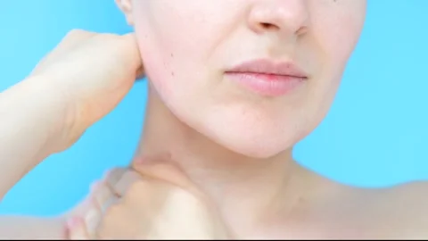 Female hands do self-massage of neck close-up on blue background. Stock Footage 169589828