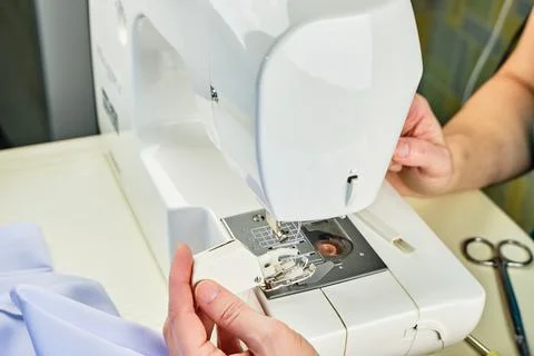 Female hands doing maintenance work on a domestic sewing machine Stock Photos