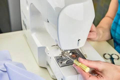 Female hands doing maintenance work on a domestic sewing machine Stock Photos