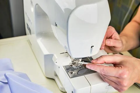 Female hands doing maintenance work on a domestic sewing machine Stock Photos