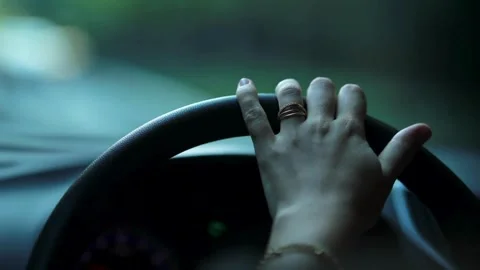 Female hands of the driver on the steering wheel while driving a car on asphalt Stock-Footage 336266433