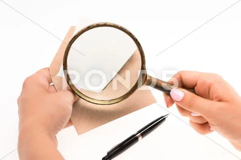 The female hands with envelope with magnifying glass on white background Stock Photos