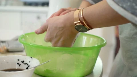 Female hands fill the plastic form with cheese. Making cheese at home. Video stock 162065862
