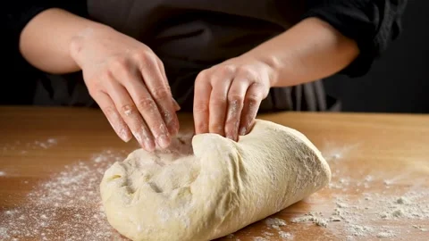 Female hands folding the bread dough in slow motion 4K - 120fps Stock Footage 266224891