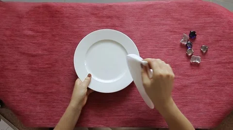 Female hands folding white textile napkin like a pavilion. Table decoration. Stock Footage 64543865