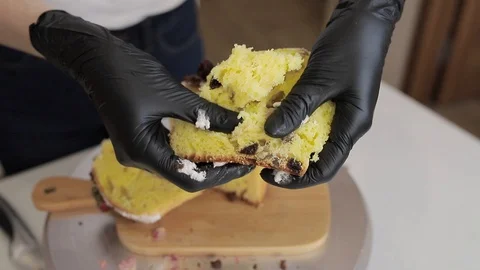 Female hands in gloves break baking closeup Stock Footage 128567105