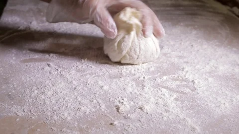Female hands in gloves roll out dough Video stock 111685083