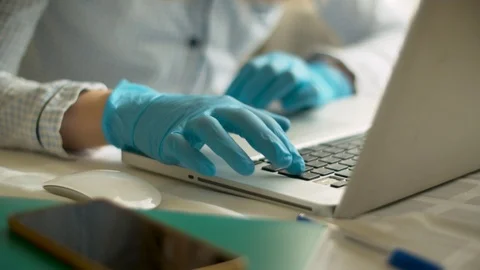 Female hands in gloves typing on a computer Stock Footage 126819009