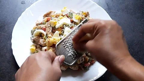 Female hands grating cheese on cooked food Stock Footage 171872924