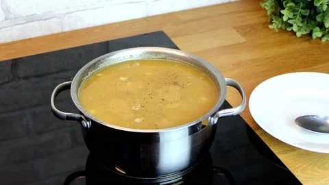 Female hands grind pepper in a mill, lentil and pea soup is cooked Stock Footage 170610207