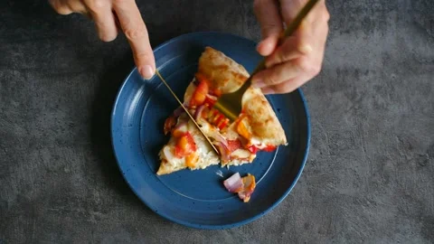 Female hands hold fork cutting slice of pizza with knife Stock-Footage 282076603