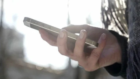 Female hands hold a smartphone, using smartphone, texting, typing message Video stock 87087936