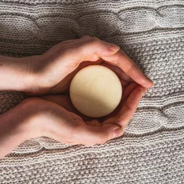 Female hands hold solid shampoo bar Stock Photos