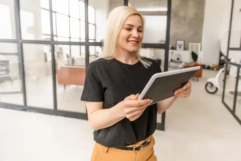 Female hands hold a tablet computer with system clever house on a screen Stock Photos