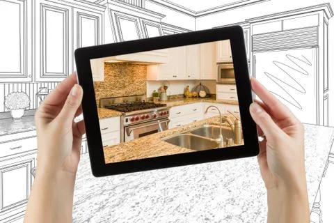 Female Hands Holding Computer Tablet with Kitchen on Screen &amp; Drawing Behind. Stock Photos