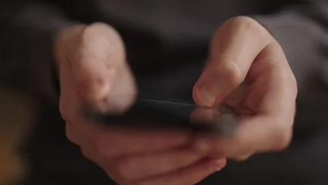 Female hands holding modern smartphone, with fingers scrolling through screen Stock Footage 321961964